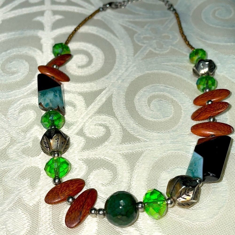 Asymmetrical bead necklace unique beads in green, blue, black, brown, & silver